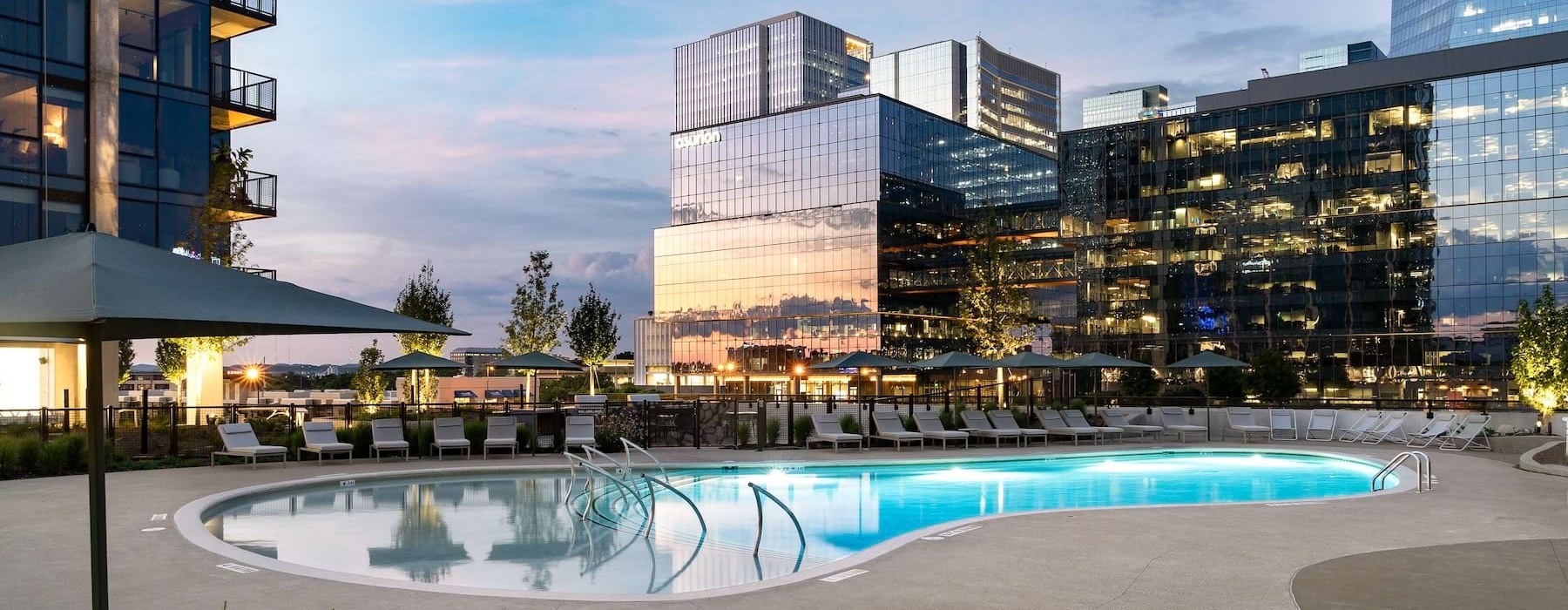 Swimming pool area with city buildings in the background