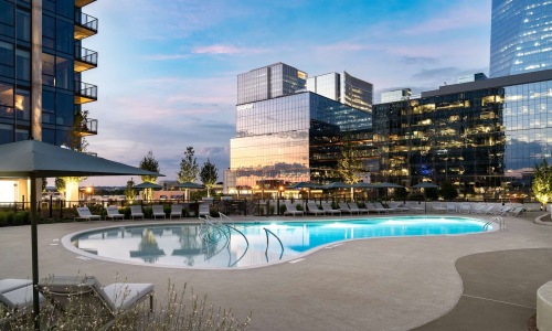 Swimming pool area with city buildings in the background