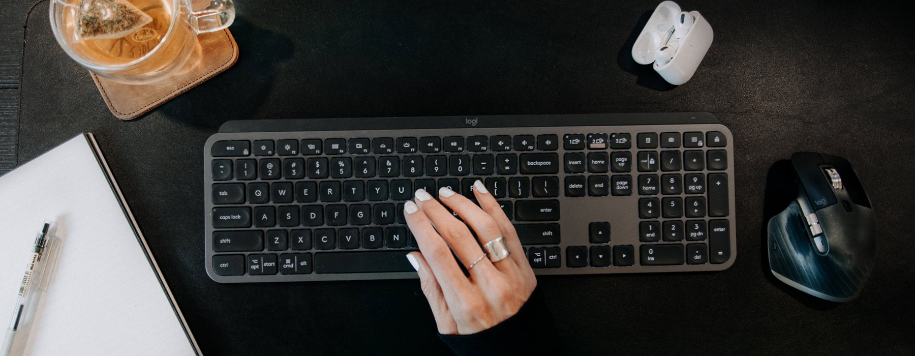 hand on keyboard with coffee